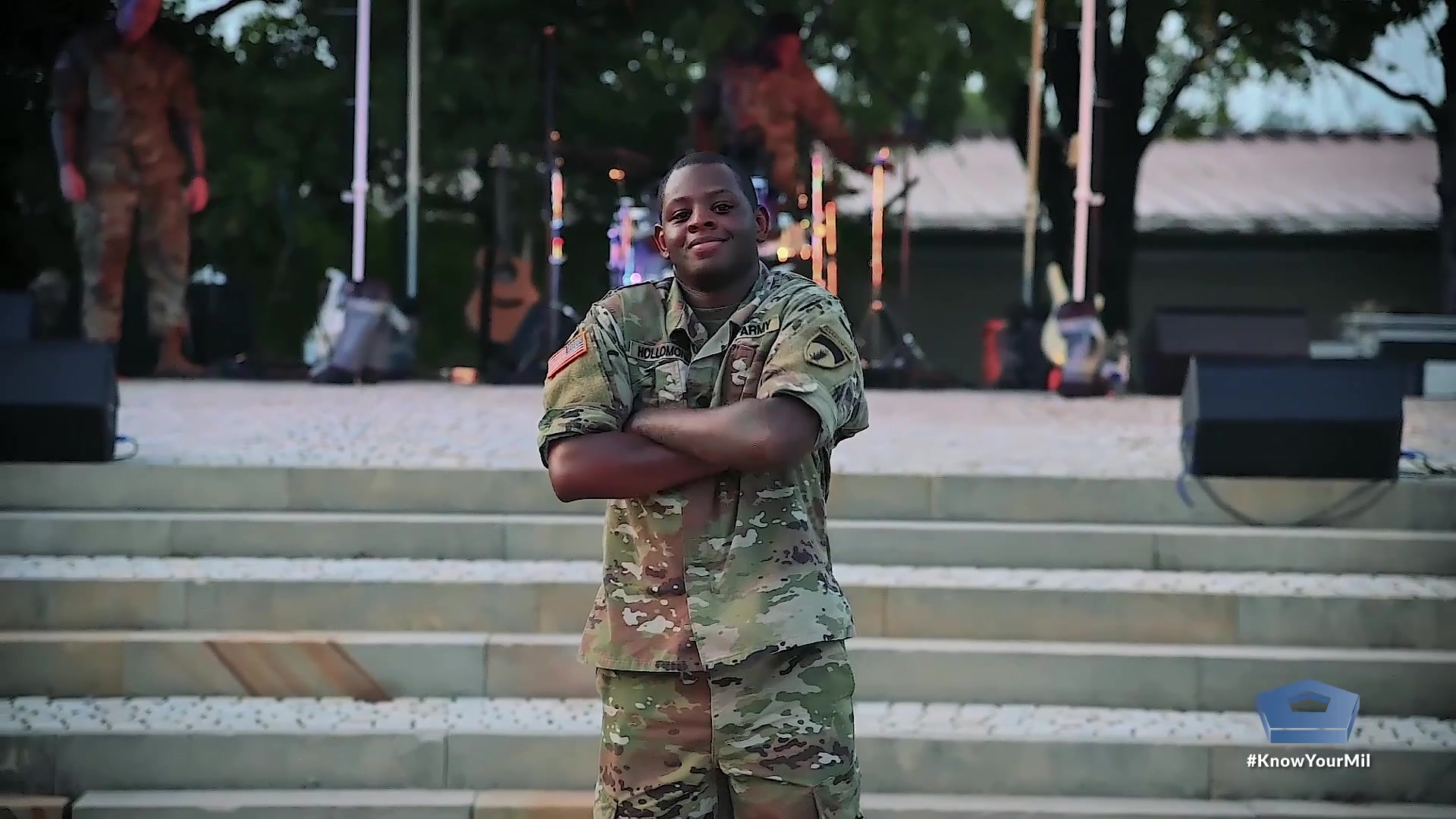 A soldier stands with his arms crossed. 